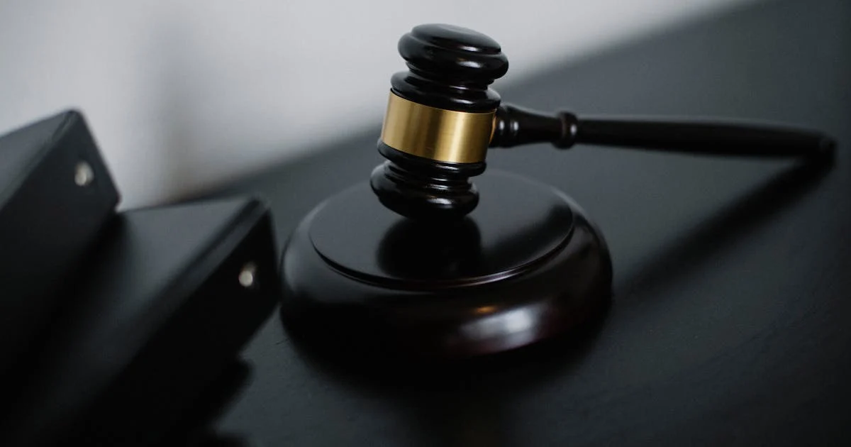 A family law solicitor consulting with a couple in a professional Australian legal office, documents on the desk between them