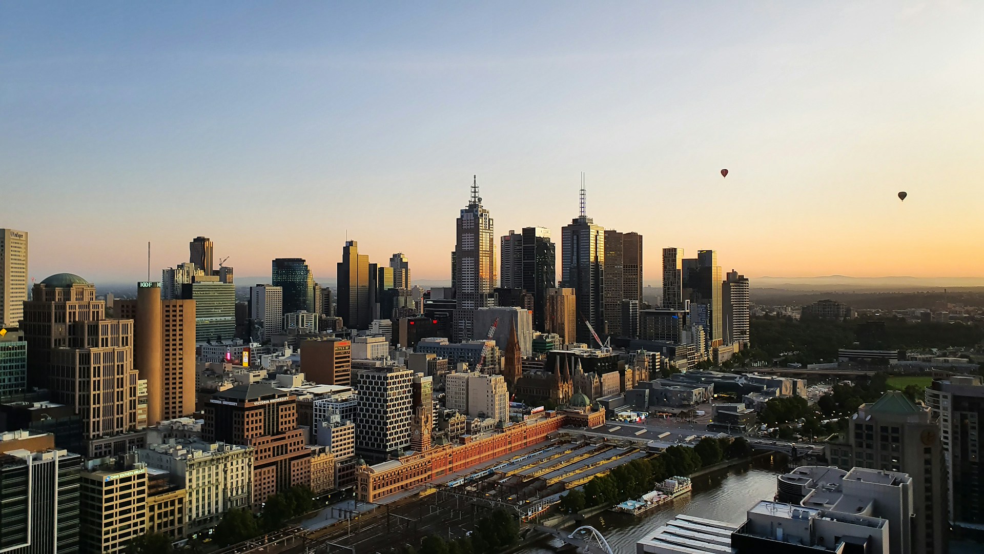 View of Melbourne skyline with hot air baloons in distance