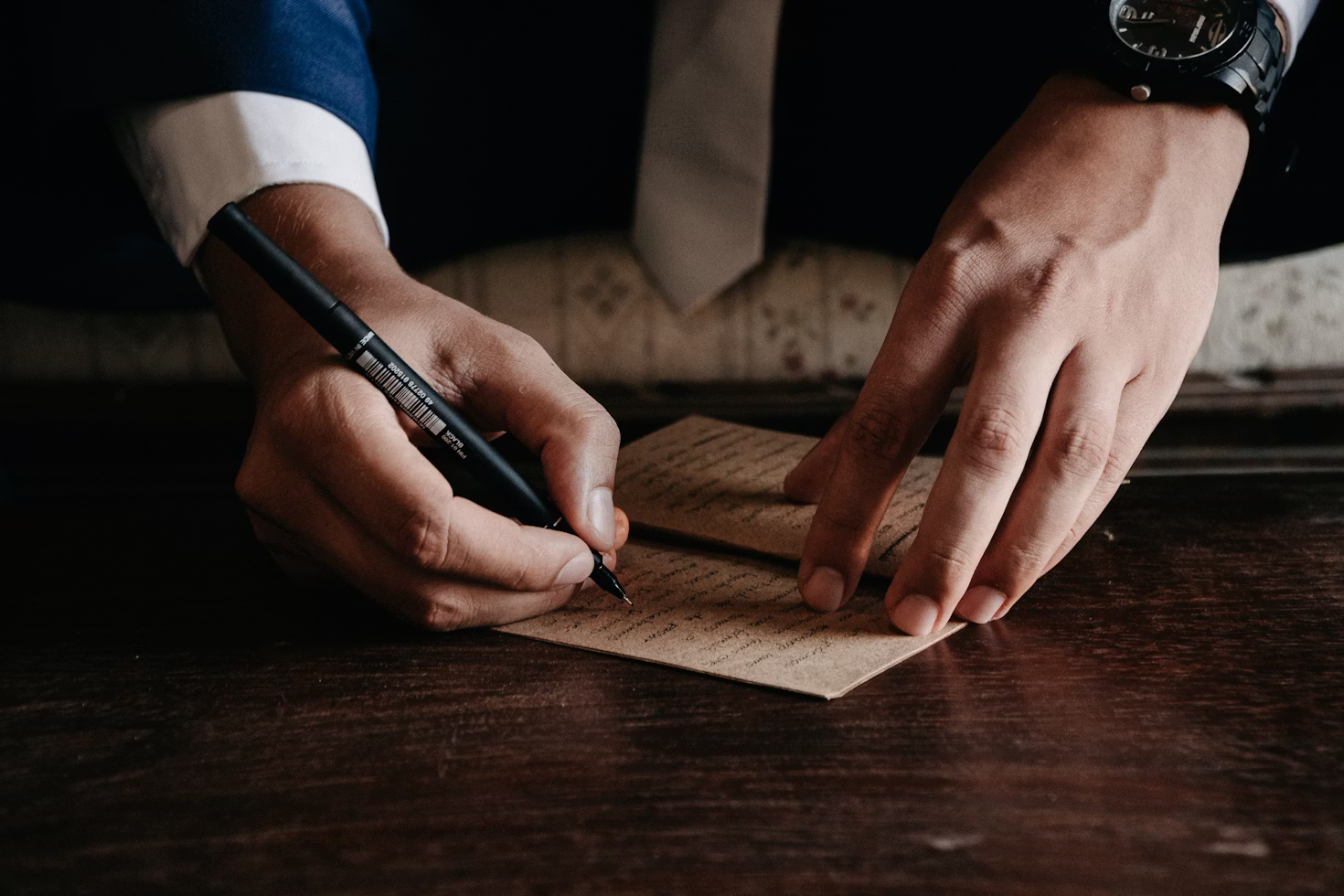 Signing document on wooden desktop