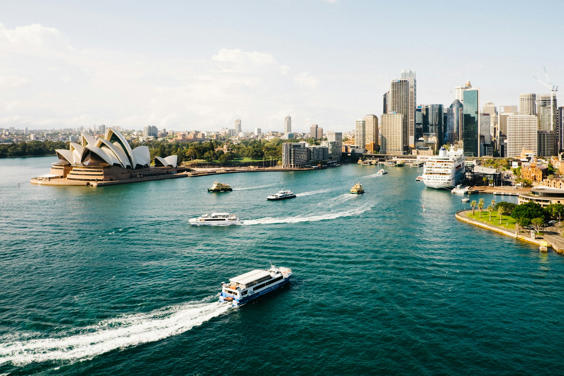 Aerial view of Sydney harbour & opera house with city behind.